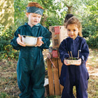 Two children, one with a bandana, stand outside wearing Originals Waterproof Puddle Suits. The boy holds a pot, and the girl holds a plant.